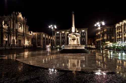 Immagine con piazza, notturno, monumento, pioggia, riflesso, lampioni, luci, chiesa, colonna, riflessi, palazzi, obelisco